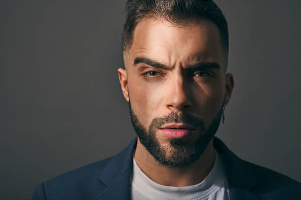 istock Male model shot in studio. Serious and confident expression. Angry or upset look and a casual style. 1384830940