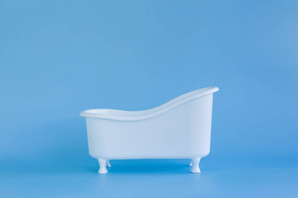 istock Empty white bathtub toy on a blue background and soap bubbles foam 1384833356