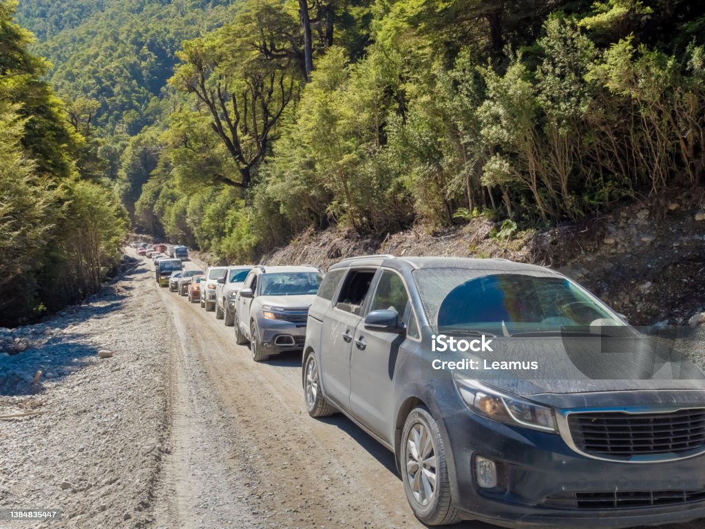 Road work traffic along the  dusty gravel carretera Austral (Southern Way), Chile's Route 7 near Puyuhapi, Chile. Car Stock Photo