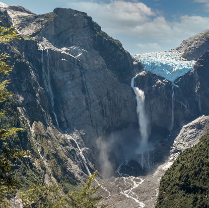 El Glaciar Colgante (Ventisquero Colgante) con su impresionante cascada con agua de merluza cayendo en una sola gota vertical, Parque Nacional Queulat, Patagonia, Chile photo