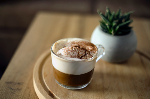 Mocha or Espresso con panna, coffee with whipped cream on a table.