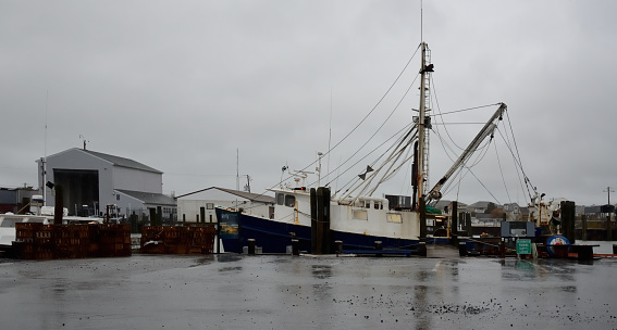 A Marina in West Ocean City, Maryland,USA on a cold, rainy mid-March day with a trawler and all its paraphernalia preparing to set out