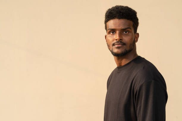 istock Portrait of handsome African man wearing oversized black t-shirt 1384846310