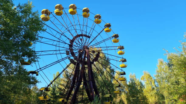 istock Abandoned famous amusement park surrounded with trees in a ghost town Pripyat, Ukraine, devastated after a disaster at Chernobyl nuclear power plant 1384846671
