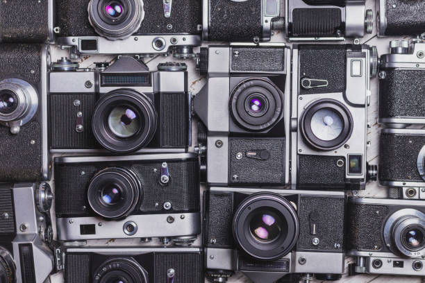 istock Old retro cameras lie in rows to each other 1384849153