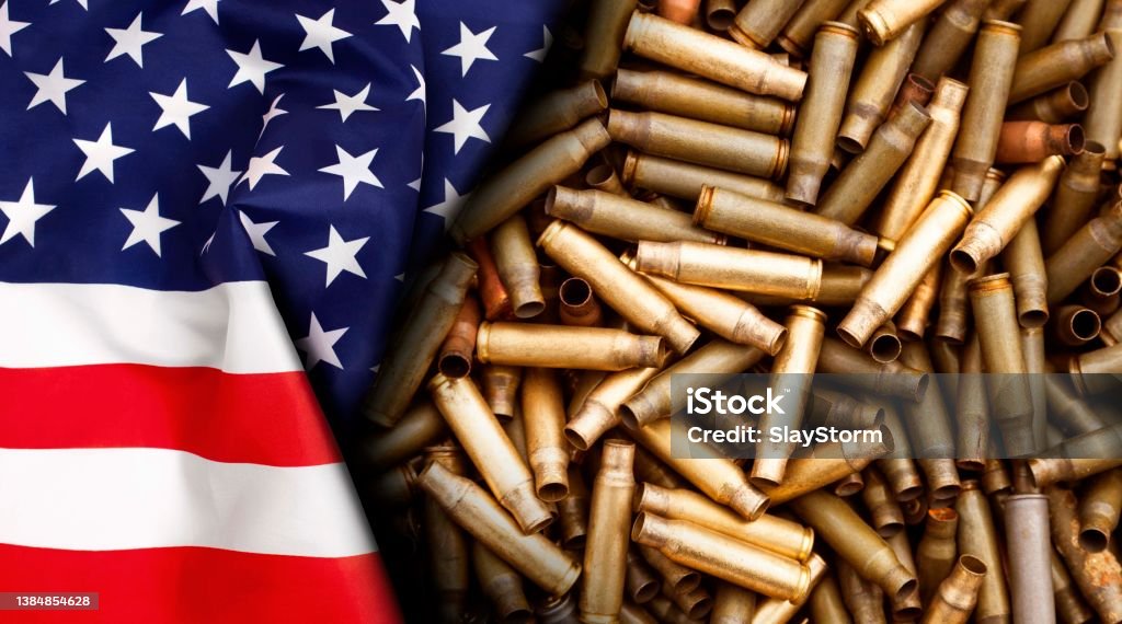American flag isolated on shotgun cartridges background American flag isolated on shotgun cartridges background. Top view, copy space for text. Gun Stock Photo