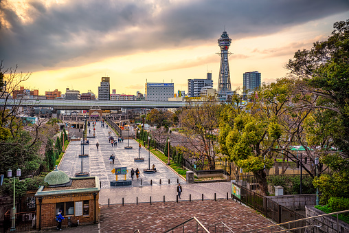 Osaka, Japan - March 28, 2019: View of Tennoji Park with Tsutenkaku tower at sunset, Osaka. Japan