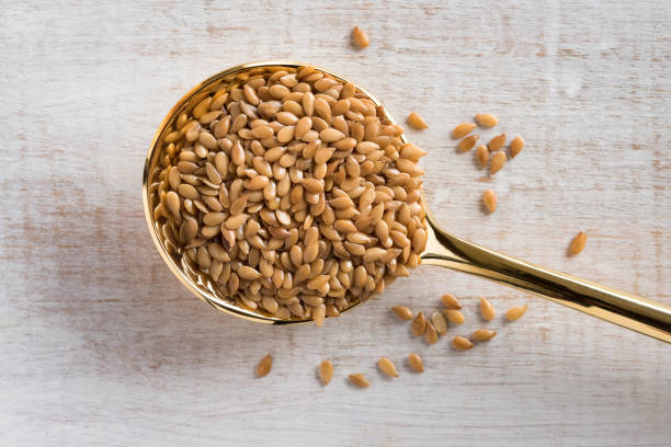 Gold Flaxseeds Spilled from a Spoon stock photo