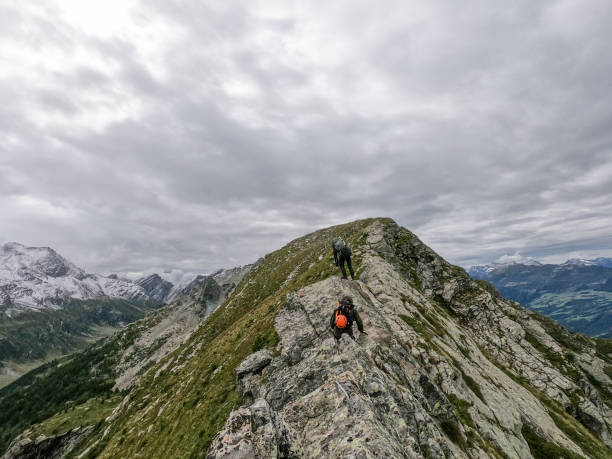 istock Two friends hiking on a mountain ridge 1384856497