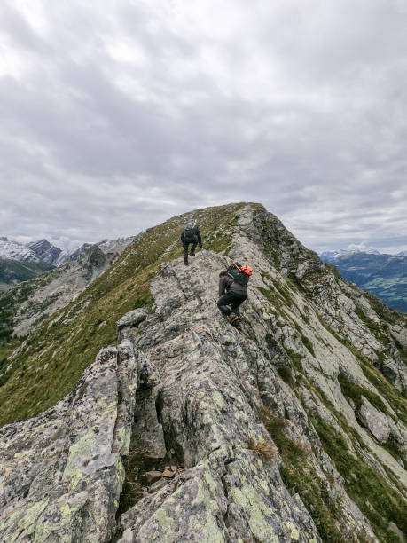 istock Two friends hiking on a mountain ridge 1384856501