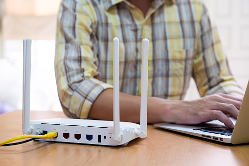 Man Using A Router Selective Focus At Router Internet Router On Working Table With Blurred ...