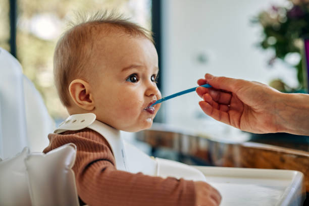 istock Adorable baby boy during lunchtime 1384857646