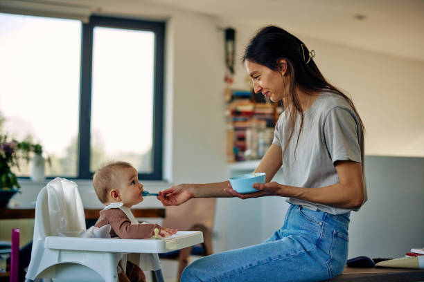 istock Happy baby and mother during lunchtime 1384857654