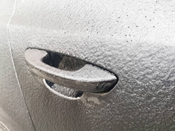istock iced frozen car door handle close up. 1384858570