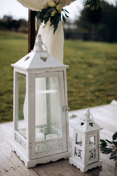 istock Wooden lanterns for candles. Wedding decorations 1384860167