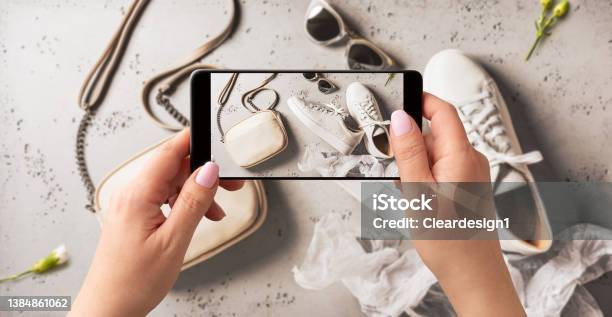Woman Taking Photo Of Spring Fashion Accessories With Smartphone Influencer And Social Media Stock Photo - Download Image Now