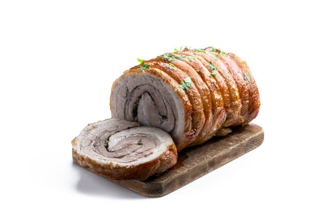 Veal paupiette with peas and carrots on a plate with a fork in closeup