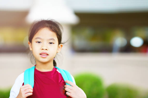 istock child with backpack on blur school background in back to school concept 1384863114