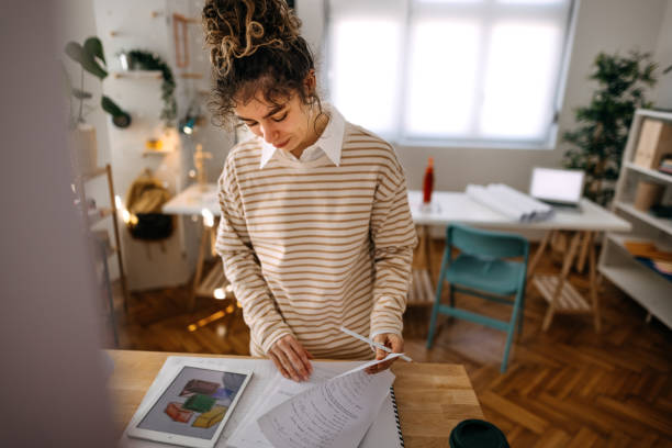 istock Businesswoman analyzing reports on desk 1384864645