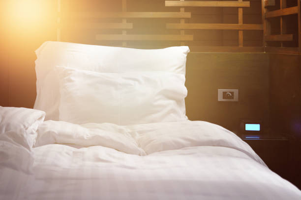 istock crumple bed sheet with sun and alarm clock 1384864948