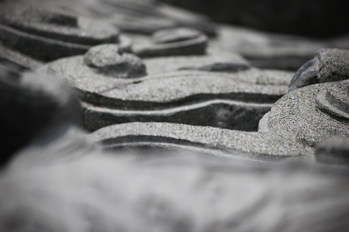A close up of intricate carvings on a grey stone surface.