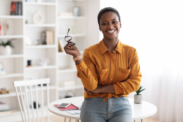 istock Happy young black woman posing at home 1384865937