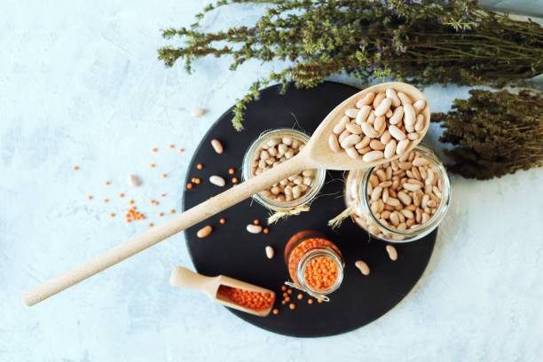istock Beans, chickpeas, lentils and dry herbs on the kitchen table 1384866339