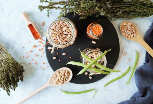 istock Beans, chickpeas, lentils and dry herbs on the kitchen table 1384866372