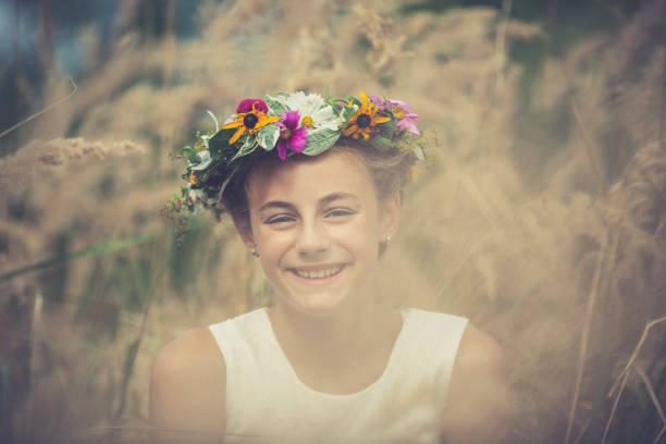 smiling girl with a flower wreath on her head.