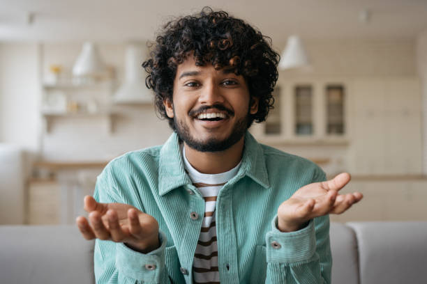 istock Indian freelancer communication online working from home, video conference concept. Smiling man having video call. Successful asian influencer recording video talking to camera 1384868156