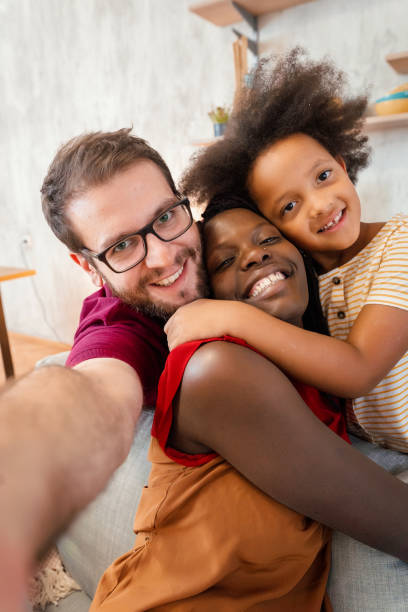 istock Multiracial parents taking selfies and having fun time together with their daughter 1384868251
