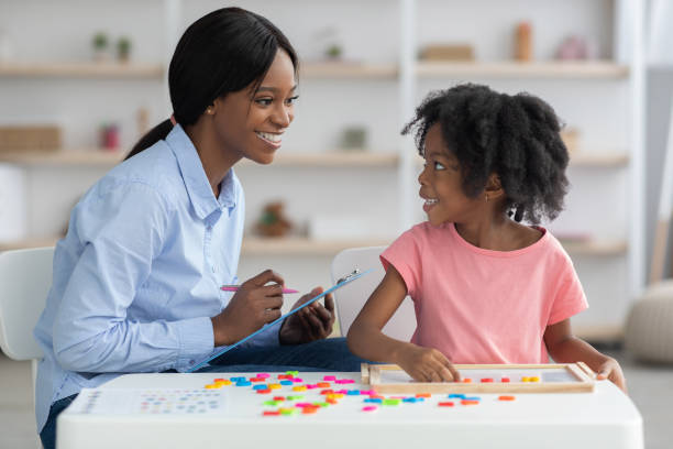istock Cheerful child development specialist testing cute little girl 1384869094