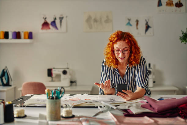 istock Young fashion designer working in her atelier 1384869648