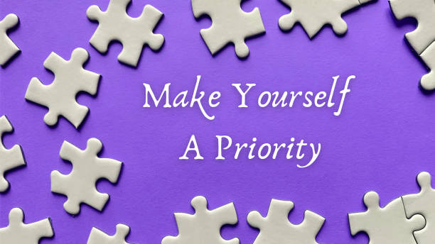 istock Motivational and inspirational quote on missing jigsaw puzzle - Make yourself a priority. 1384872299