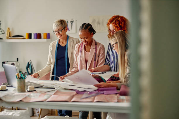 istock Creative people working together in fashion designer studio 1384872529