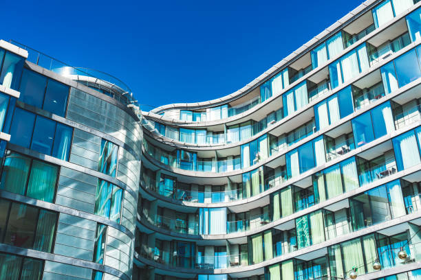 Low angle colour image depicting an abstract view of a modern architecture  apartment building built from glass and steel in the heart of the city of London, UK. Plenty of room for copy space.