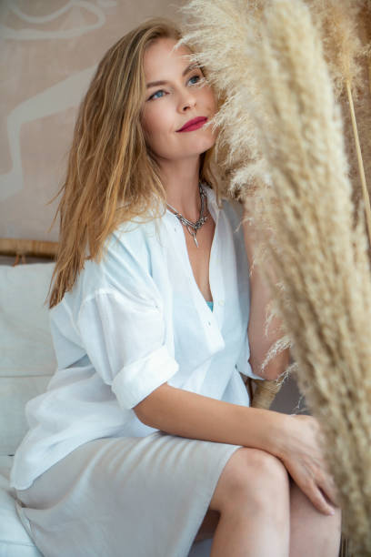 istock Beautiful fashion model posing next to pampas grass 1384875758