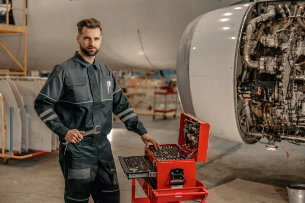 istock Bearded man aircraft mechanic using tool box in hangar 1384875994