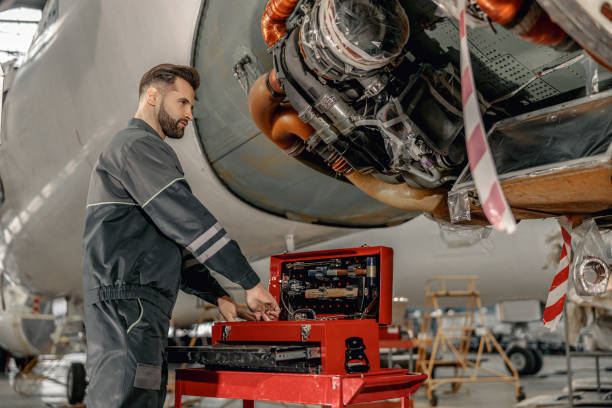 istock Bearded man aircraft mechanic using instrument box in hangar 1384876023