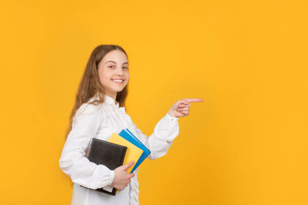 istock back to school. childhood education. knowledge day. kid hold notebook. student in high school. 1384876080