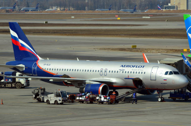 Foreign owned Russian aircraft - Aeroflot Airbus A320, Sheremetyevo International Airport, Moscow, Russia Moscow, Russia: Aeroflot Airbus A320-214 (named after zoologist Ilya Ilyich Mechnikov), with an offshore registration from Bermuda, VP-BJA (MSN 5536), leased from DAE Capital (UAE) - loading luggage at Sheremetyevo International Airport. airbus a320 stock pictures, royalty-free photos & images