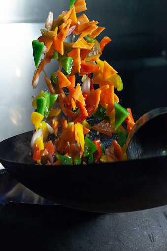 Vegetarian wok preparation on carbon steel pan with high heat temperature. Vegetables variety