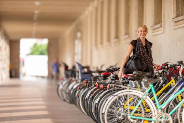 Smiling Young Woman Parking Her Bicycle.