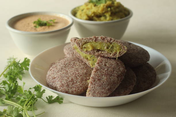 istock Potato stuffed ragi idli. Steamed finger millet cakes stuffed with smashed potato masala 1384879285