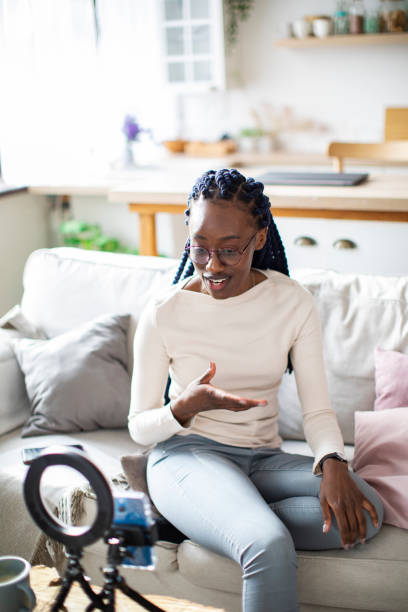 istock Young African woman vlogging from home 1384881266