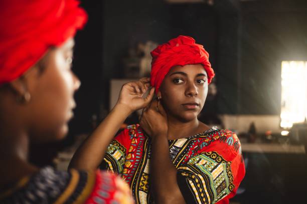 Native caribbean woman putting a turban on her head Native caribbean woman putting a turban on her head honduras stock pictures, royalty-free photos & images