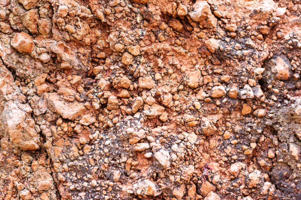 istock Empty stone wall covered with cracks of old house. 1384883717