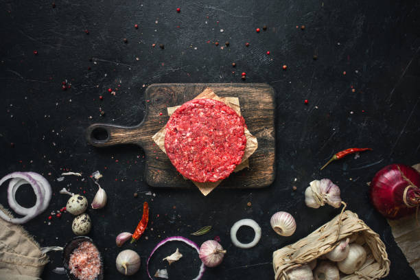 istock Raw burger patty and spices 1384886253
