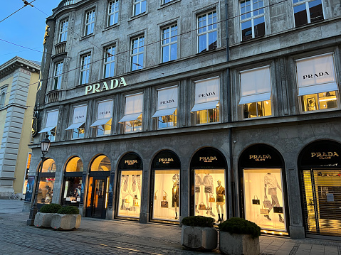 Munich, Bavaria Germany - February 22, 2022: Prada high-end fashion store, shop front with logo and window display.