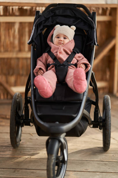 Baby girl in a buggy stock photo